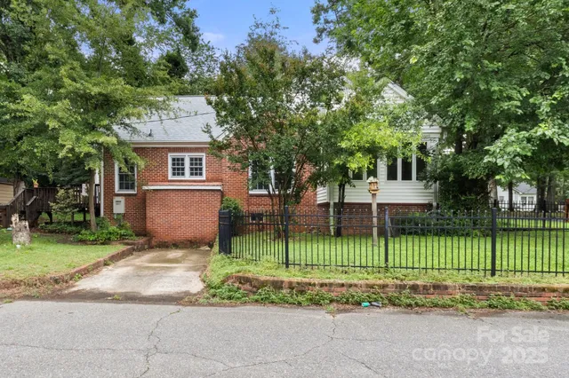 a view of a park with a large trees and plants