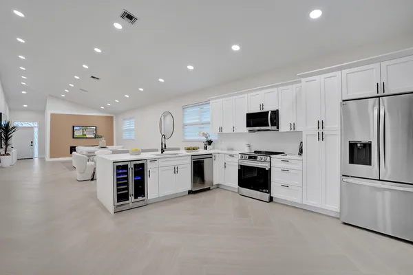 a kitchen with a sink and a stove top oven