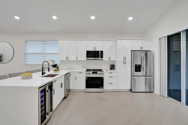 a kitchen with a sink a stove and cabinets