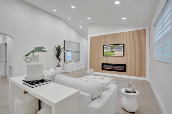 a living room with furniture and a potted plant