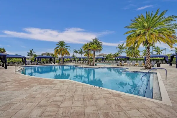 a swimming pool with outdoor seating yard and barbeque oven