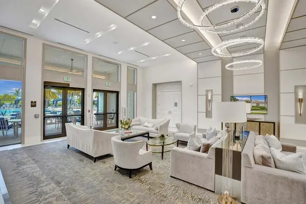 a living room with furniture and a chandelier
