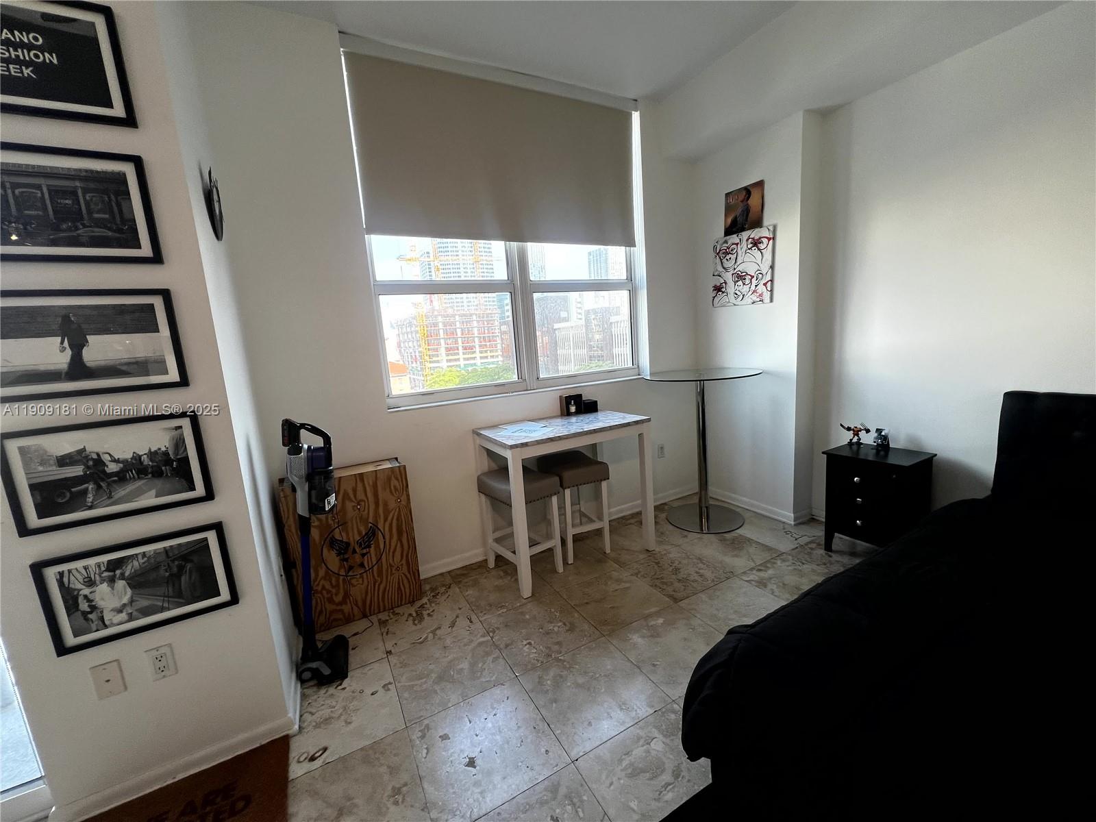 133 Northeast 2nd Avenue, Unit 617 Miami, FL 33132 - Photo 11 of 38 a dining room with furniture and a window