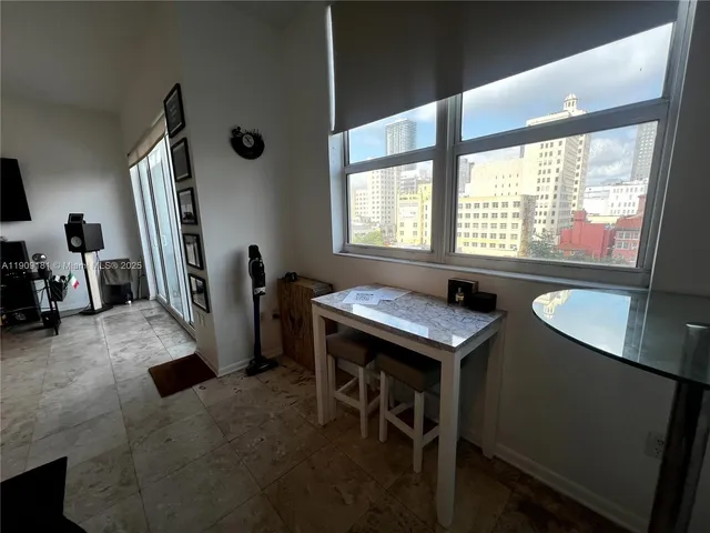 a view of a glass door and a living room filled with furniture