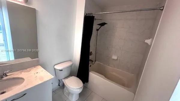 a white toilet sitting next to a bath tub
