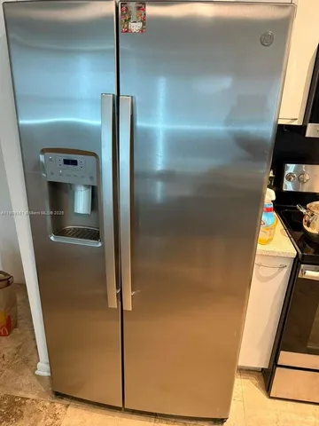 a view of a backyard with plants and a patio