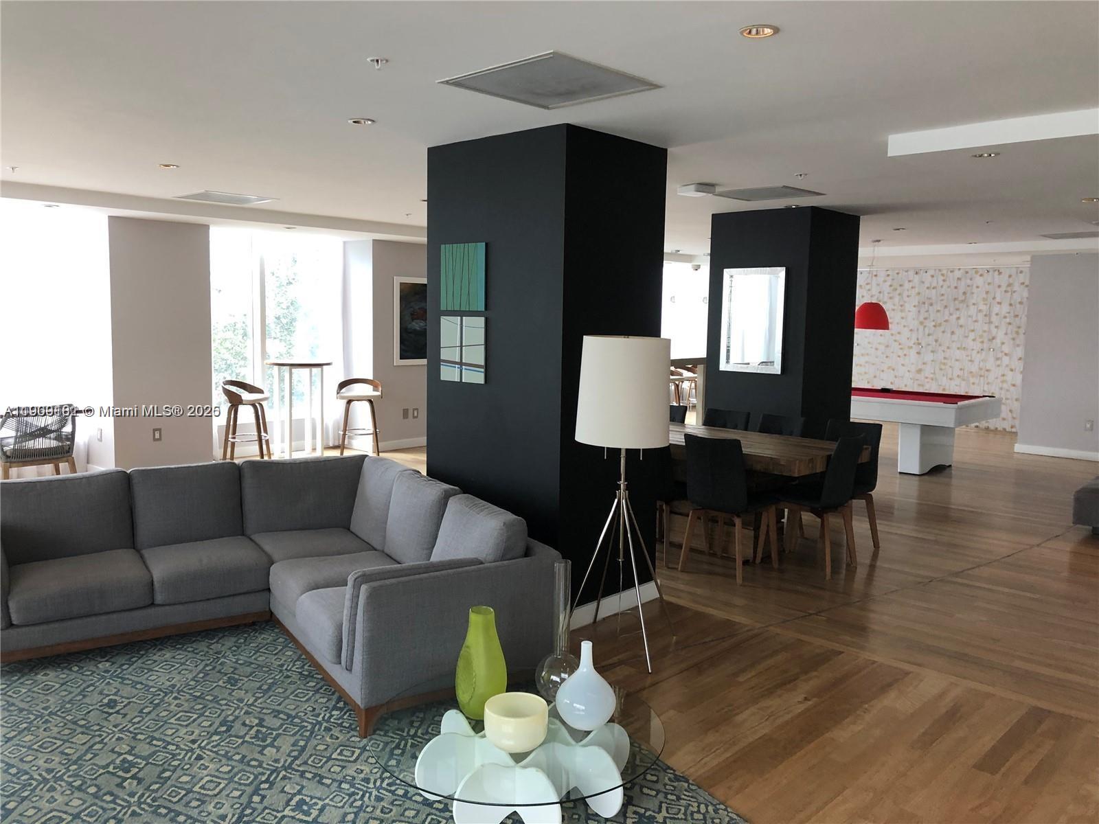 133 Northeast 2nd Avenue, Unit 617 Miami, FL 33132 - Photo 19 of 38 a living room with furniture and wooden floor