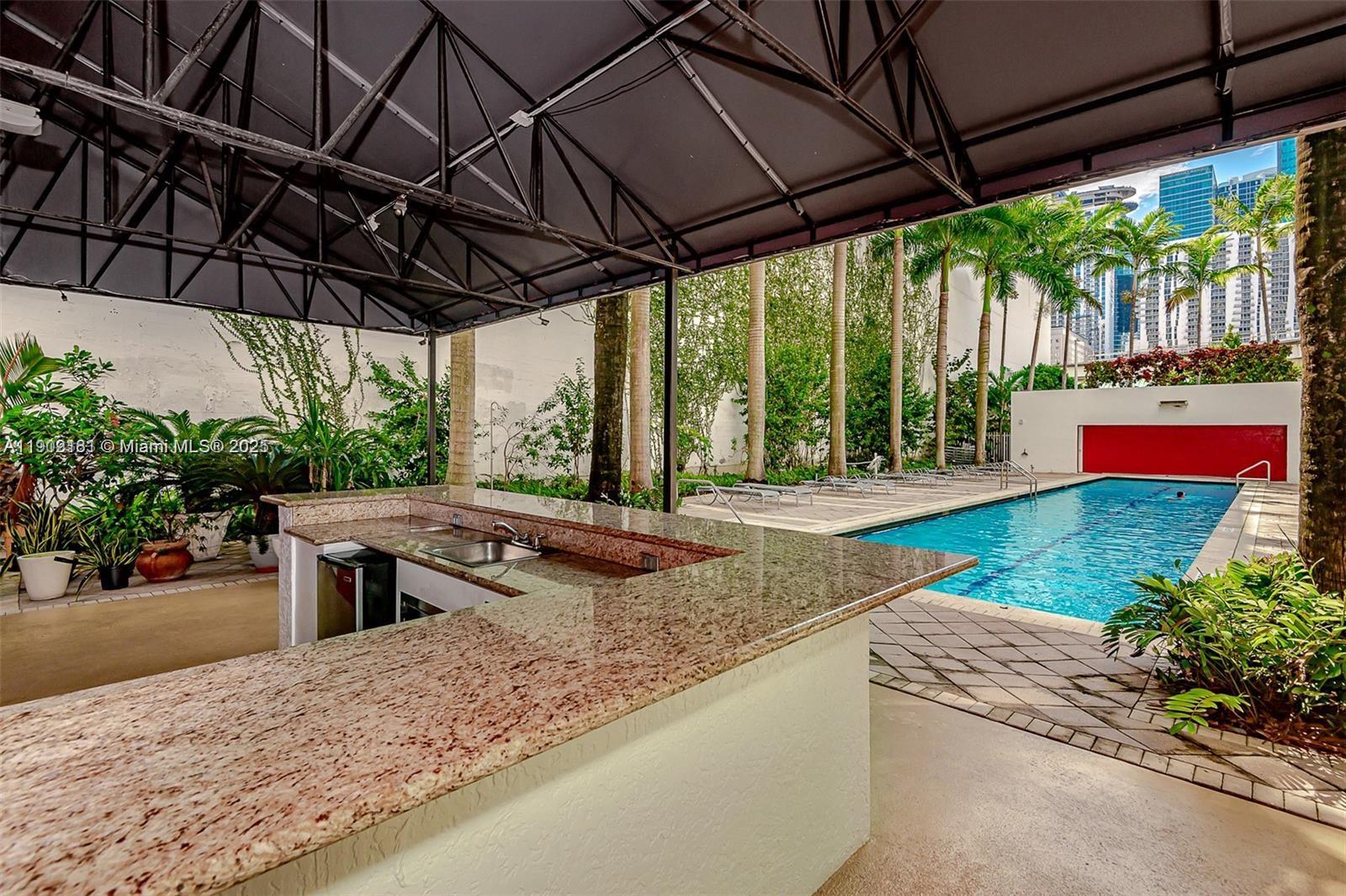 133 Northeast 2nd Avenue, Unit 617 Miami, FL 33132 - Photo 21 of 38 a view of a backyard with plants and a patio