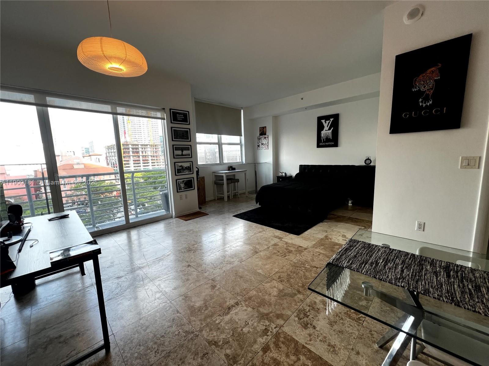 133 Northeast 2nd Avenue, Unit 617 Miami, FL 33132 - Photo 3 of 38 a living room with furniture and a flat screen tv