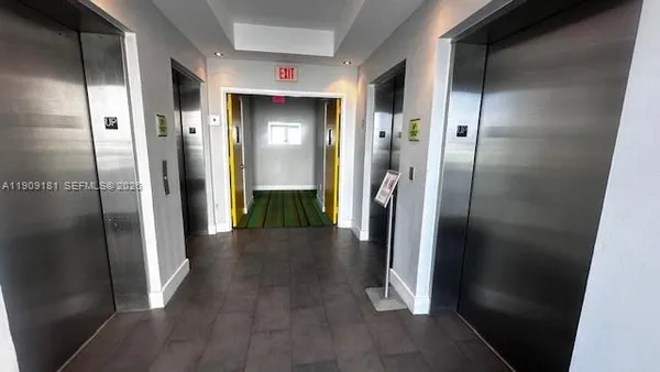 a view of hallway with wooden floor