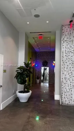 a view of living room with furniture and potted plants