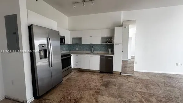 a kitchen with stainless steel appliances a refrigerator and a sink