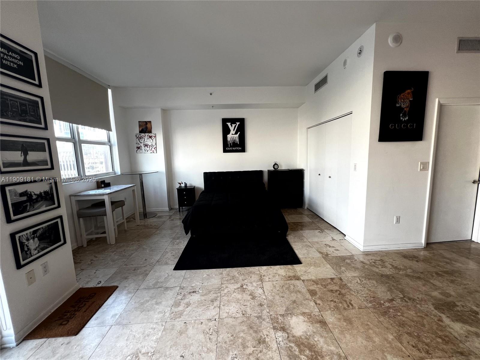 133 Northeast 2nd Avenue, Unit 617 Miami, FL 33132 - Photo 10 of 38 a living room with furniture and flat screen tv