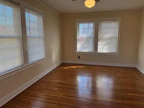 a view of a livingroom with wooden floor and window
