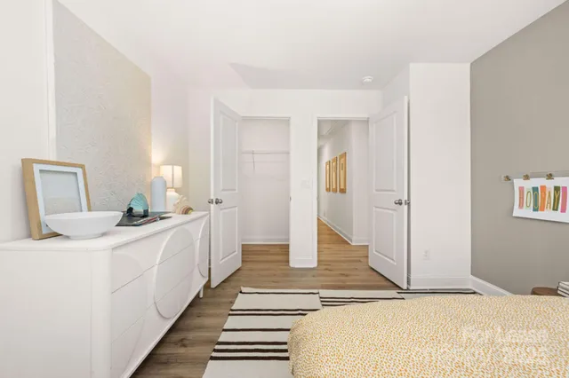 a spacious bedroom with a bed and a large mirror