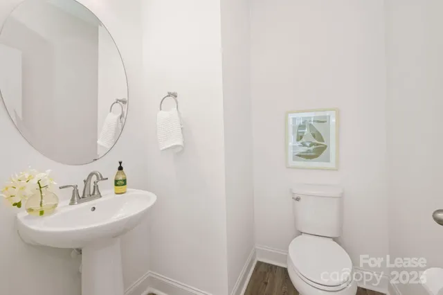 a bathroom with a sink mirror and toilet