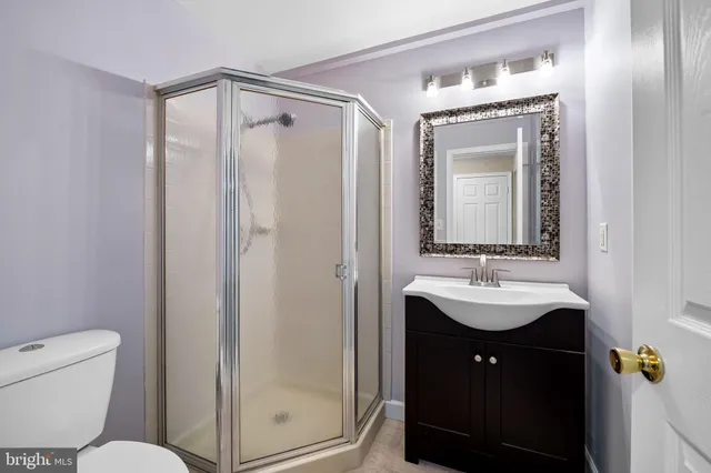 a bathroom with a toilet a sink and a mirror