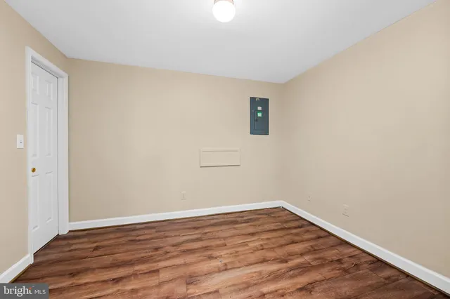 a view of a room with wooden floor and white walls