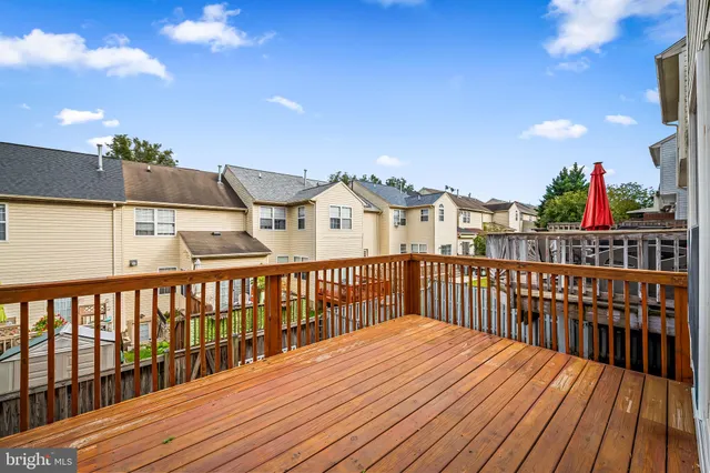 a view of balcony with wooden floor and fence