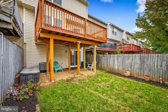 a view of a house with wooden fence