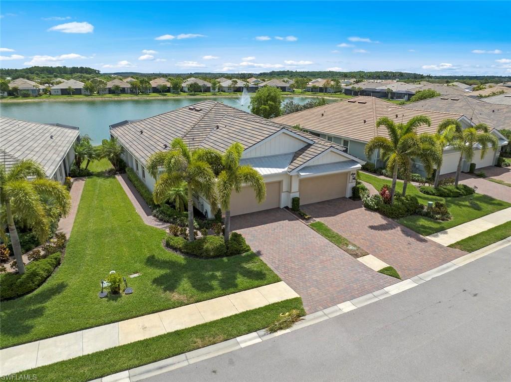 an aerial view of a house with a garden and lake view