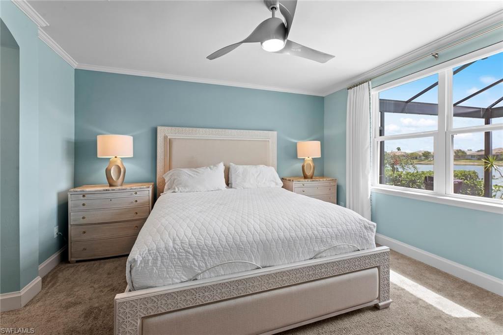 14904 Edgewater Circle Naples, FL 34114 - Photo 16 of 50 a bedroom with a large bed and a chandelier