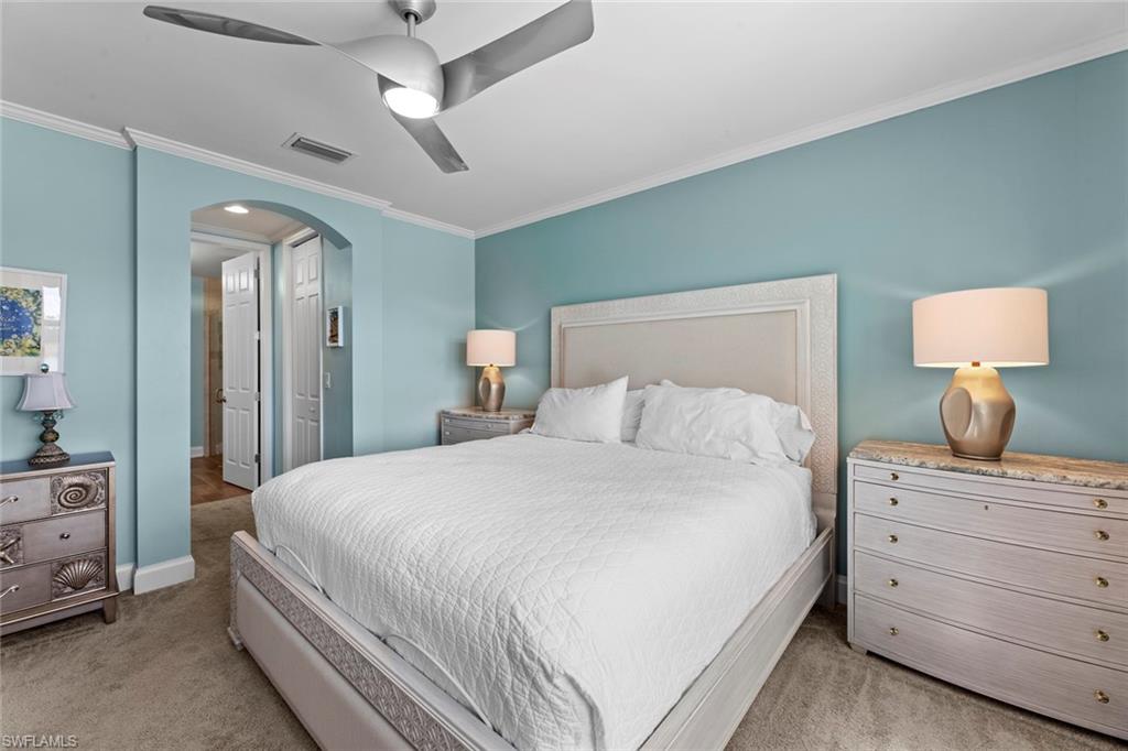 14904 Edgewater Circle Naples, FL 34114 - Photo 19 of 50 a bedroom with a bed and a dresser