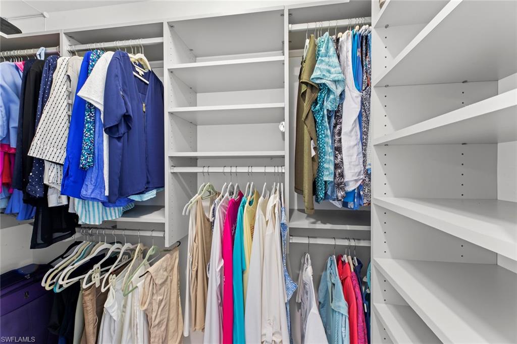 14904 Edgewater Circle Naples, FL 34114 - Photo 20 of 50 a view of walk in closet with clothes and shoes