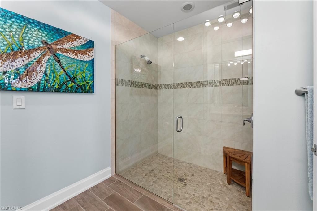 14904 Edgewater Circle Naples, FL 34114 - Photo 22 of 50 a bathroom with a glass shower door