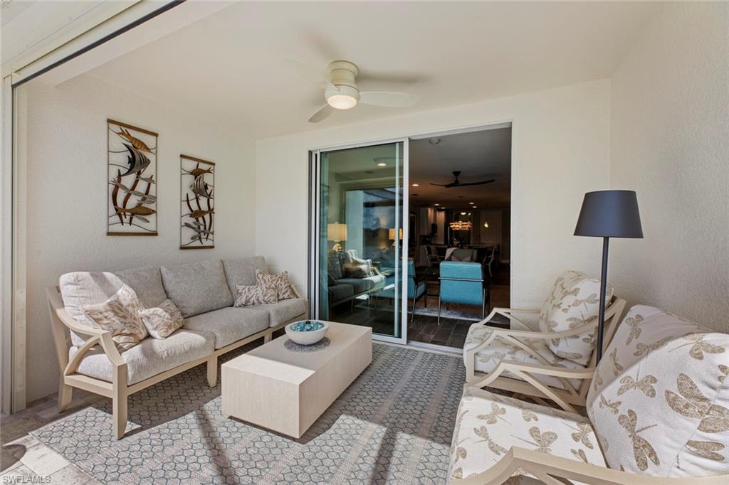 14904 Edgewater Circle Naples, FL 34114 - Photo 26 of 50 a living room with furniture and a lamp