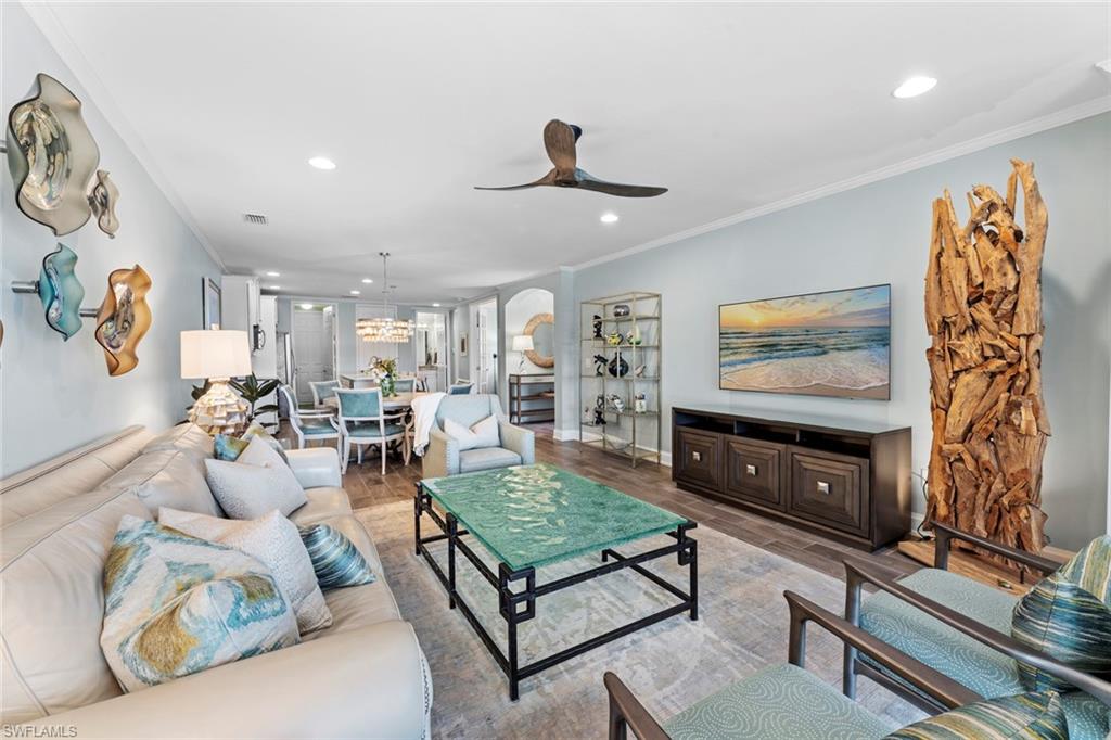 14904 Edgewater Circle Naples, FL 34114 - Photo 50 of 50 a living room with furniture and a flat screen tv