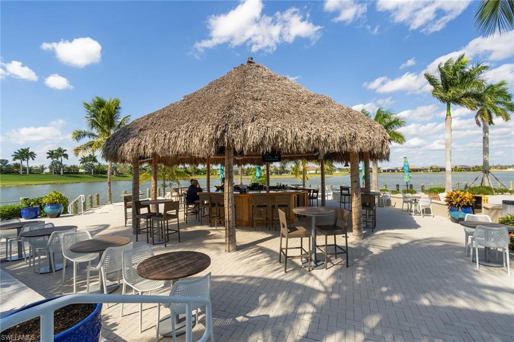14904 Edgewater Circle Naples, FL 34114 - Photo 44 of 50 a view of a patio with chairs and tables