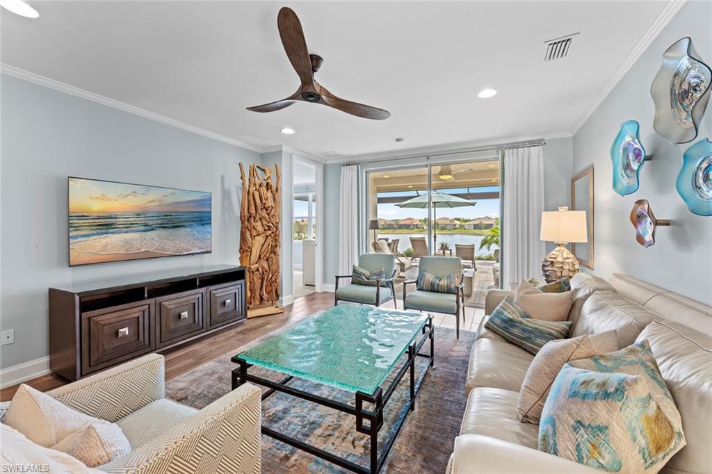 14904 Edgewater Circle Naples, FL 34114 - Photo 4 of 50 a living room with furniture and a flat screen tv