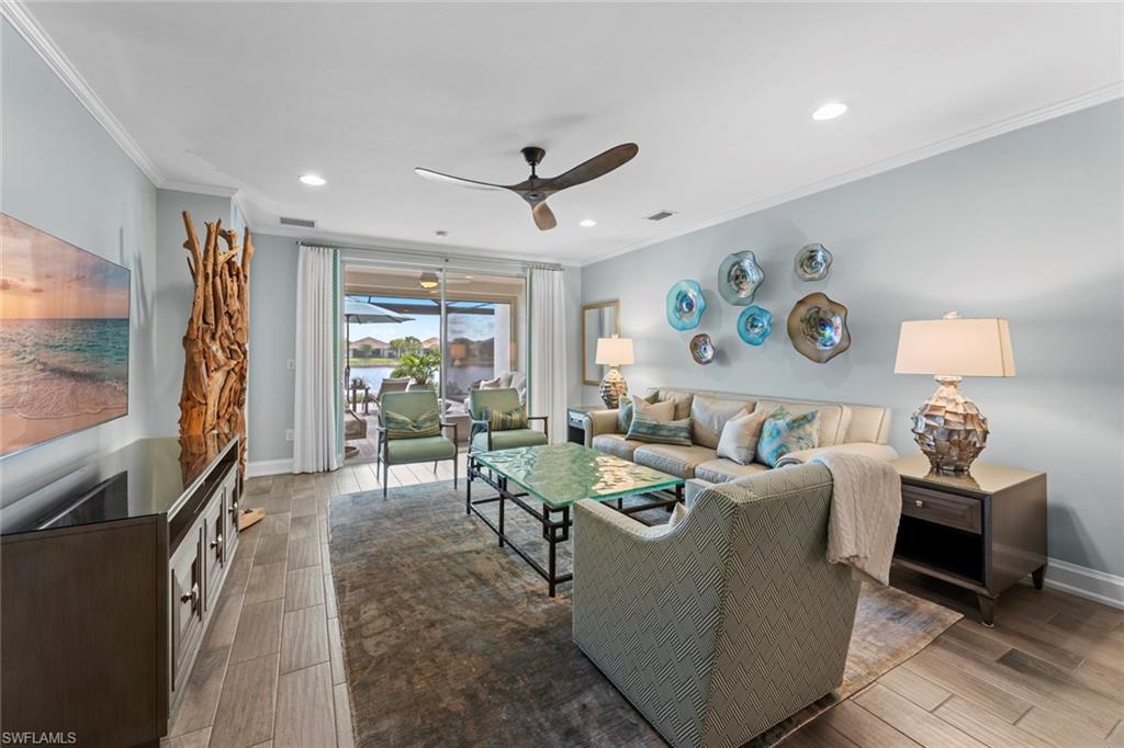 14904 Edgewater Circle Naples, FL 34114 - Photo 5 of 50 a living room with furniture and a flat screen tv