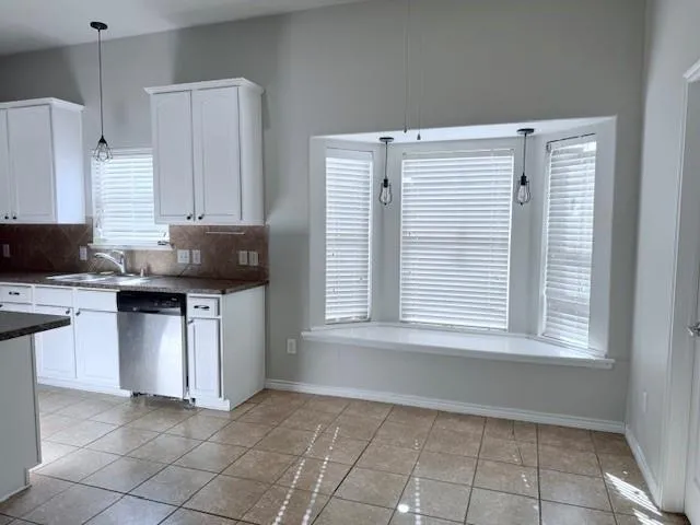 a kitchen with a stove a sink and a refrigerator