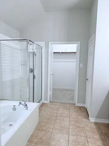 a bathroom with a bathtub and shower