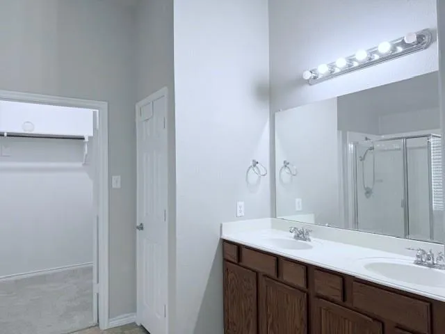 a bathroom with a sink double vanity and a mirror