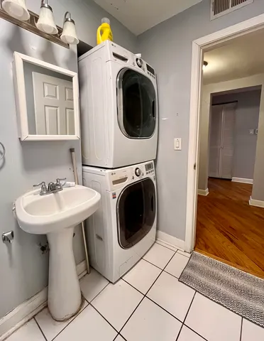 a bathroom with a sink and a washer dryer