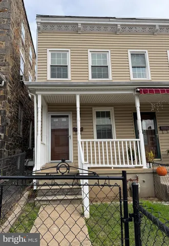 a front view of a house with a bench