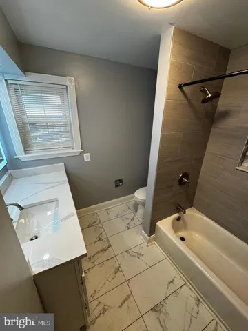 a bathroom with a bathtub and a window