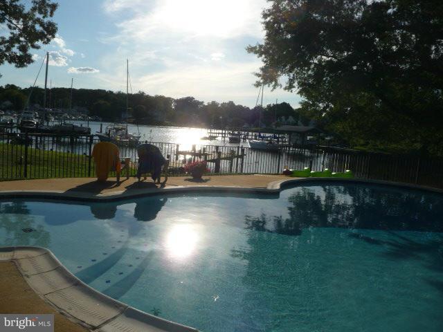 1201 Daves Road Edgewater, MD 21037 - Photo 1 of 30 a view of a lake with houses in the back
