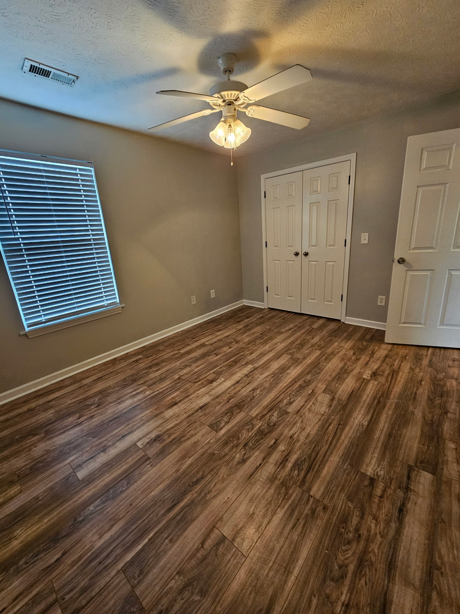 4311 Cap Davis Court Murfreesboro, TN 37129 - Photo 11 of 14 a view of an empty room with wooden floor and a ceiling fan