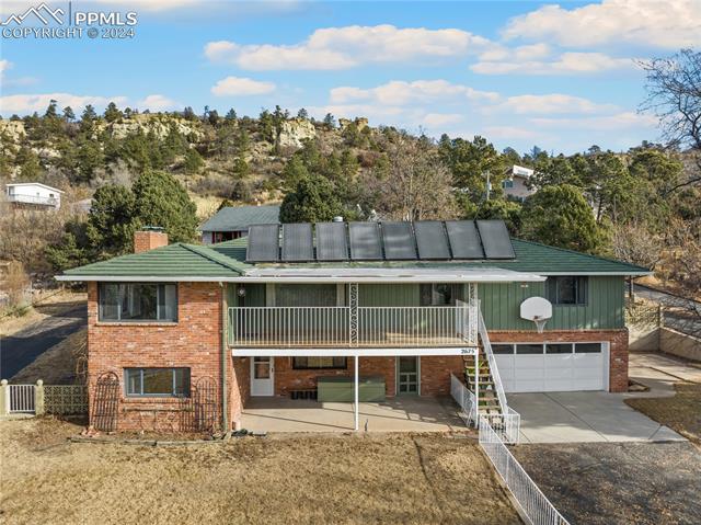 2675 North Chelton Road Colorado Springs, CO 80909 - Photo 4 of 30 South Facing Living Area and Yard/Driveway