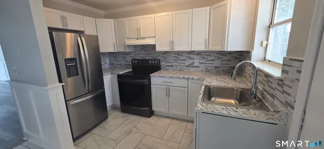 a kitchen with a refrigerator stove and sink