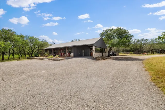 a view of house with backyard and sitting area