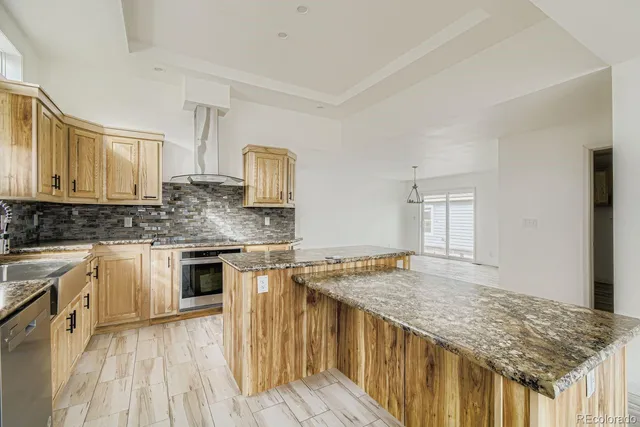 a kitchen with stainless steel appliances granite countertop a stove sink and cabinets