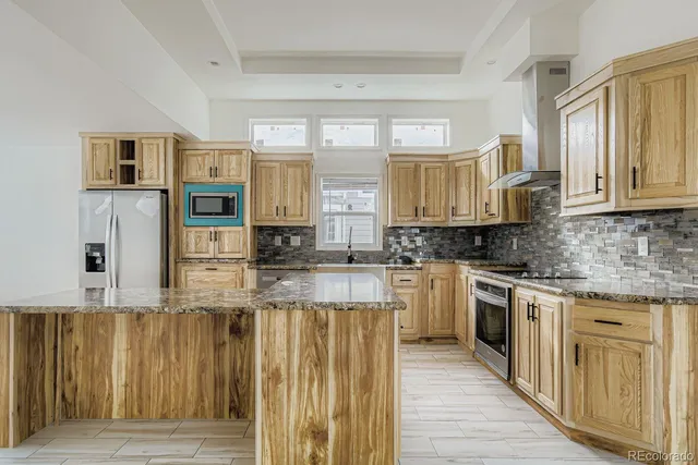 a kitchen with stainless steel appliances granite countertop a stove and cabinets