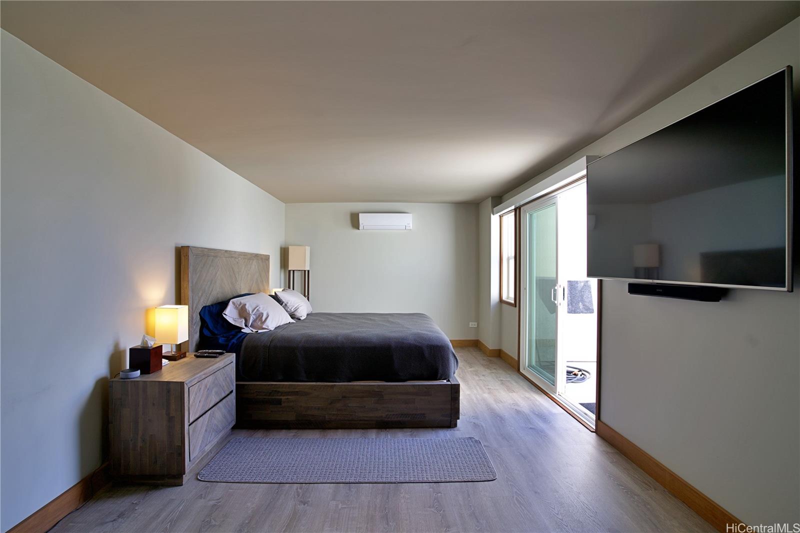 2211 Ala Wai Boulevard, Unit P6 Honolulu, HI 96815 - Photo 17 of 24 a bedroom with a bed and a view of kitchen