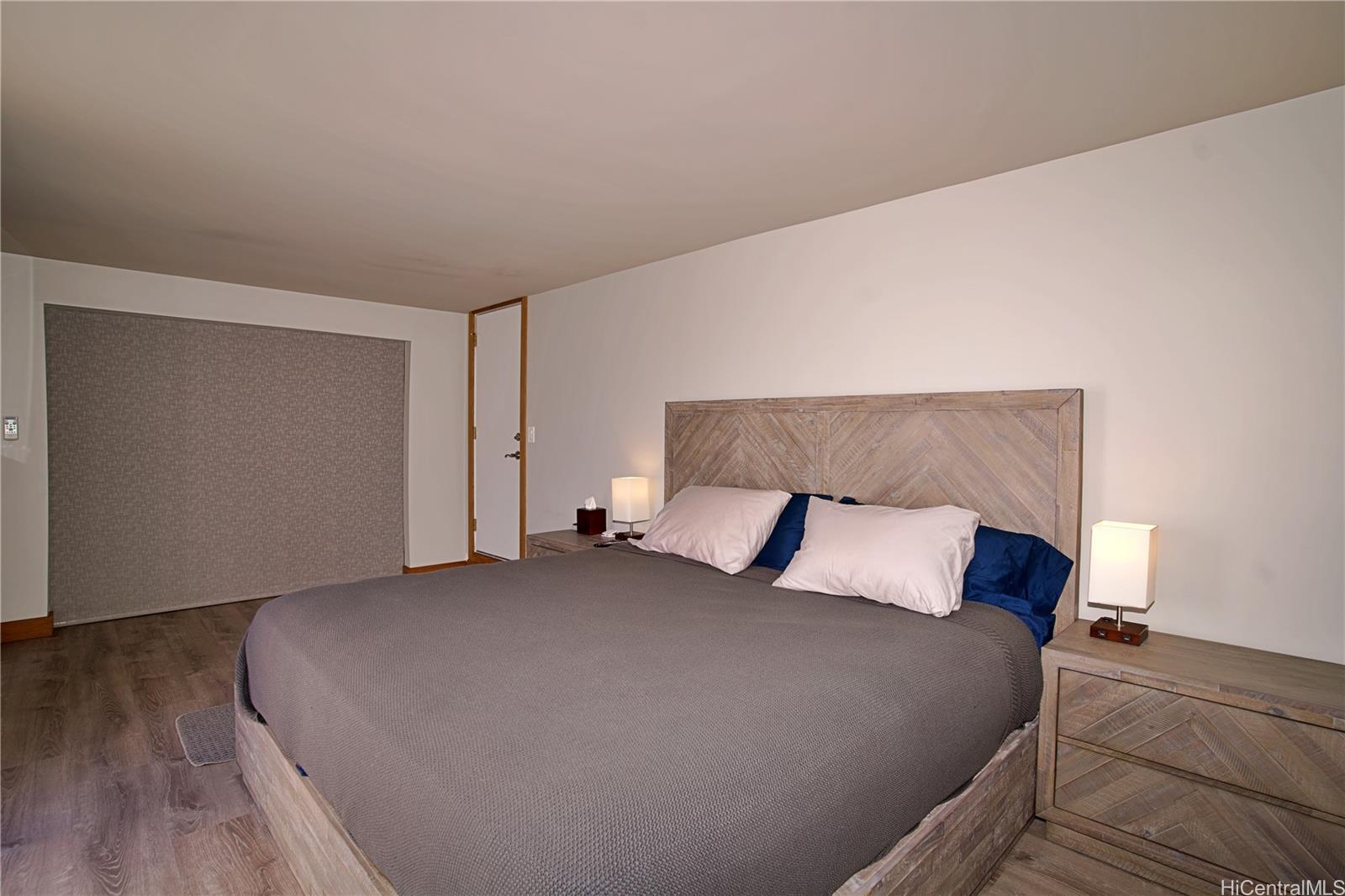 2211 Ala Wai Boulevard, Unit P6 Honolulu, HI 96815 - Photo 19 of 24 a bedroom with a bed and a night stand