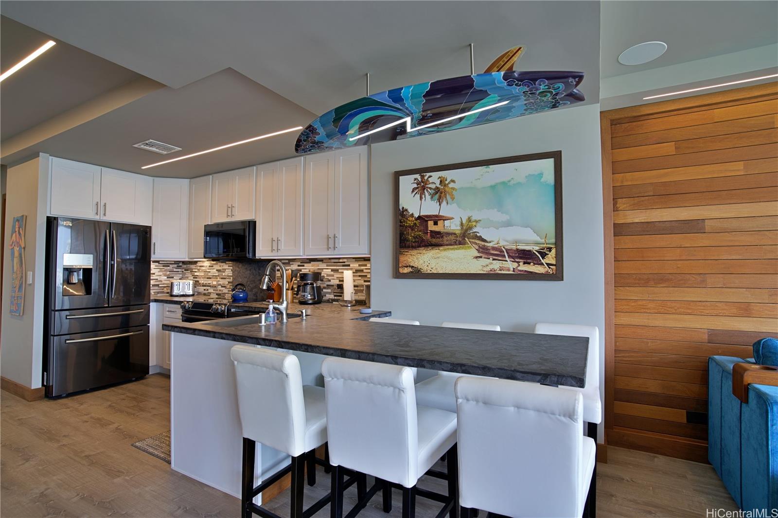 2211 Ala Wai Boulevard, Unit P6 Honolulu, HI 96815 - Photo 6 of 24 a kitchen with stainless steel appliances granite countertop a refrigerator a stove top oven a sink and dishwasher